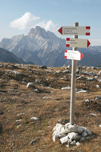 Information sign on landscape against sky