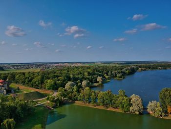 High angle view of river amidst trees against sky