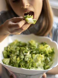 Little girl eat salad