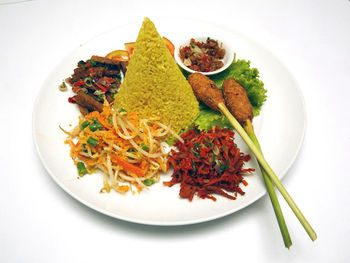 High angle view of nasi tumpeng served in plate on table