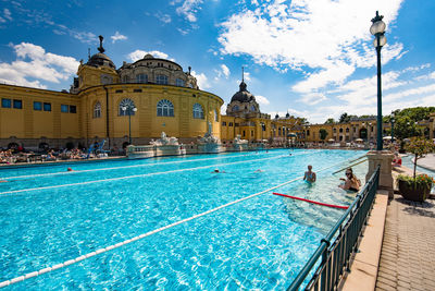 Swimming pool by buildings in city