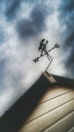 Low angle view of building against cloudy sky