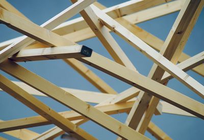 Low angle view of wooden structure against blue sky