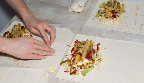 High angle view of person preparing food on table