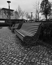 Empty benches on footpath in park