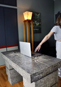 Woman standing by laptop at home