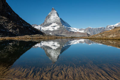 Reflection of mountain peak in calm lake