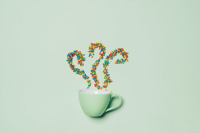 Directly above shot of multi colored candies against white background