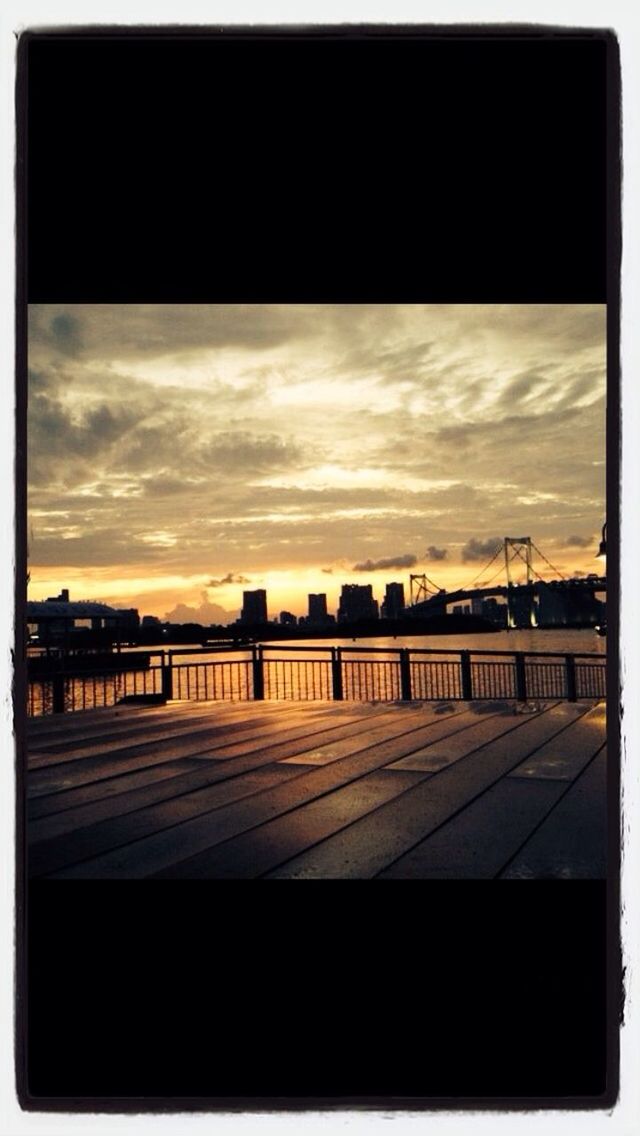 transfer print, sunset, sky, auto post production filter, built structure, architecture, water, cloud - sky, railing, building exterior, river, cloud, silhouette, city, reflection, dusk, cloudy, bridge, no people, outdoors