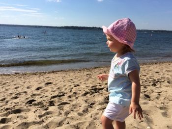 Full length of girl enjoying at beach