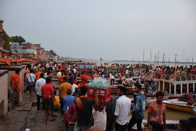 Group of people in market against buildings in city