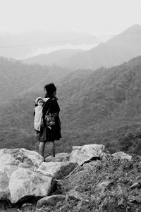 Rear view of man standing on mountain