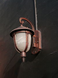 High angle view of electric lamp hanging on wall