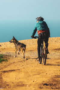 Rear view of man riding horse