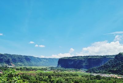 Scenic view of landscape against blue sky