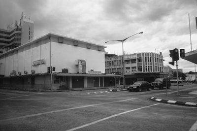 Vehicles on road against buildings in city