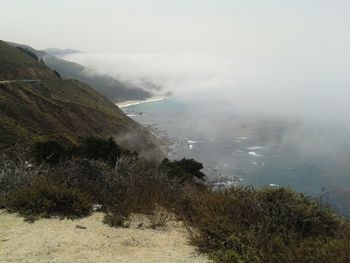 Scenic view of sea and mountains against sky