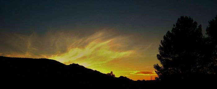 Low angle view of silhouette mountain against sky during sunset