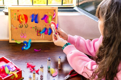 High angle view of girl drawing on table