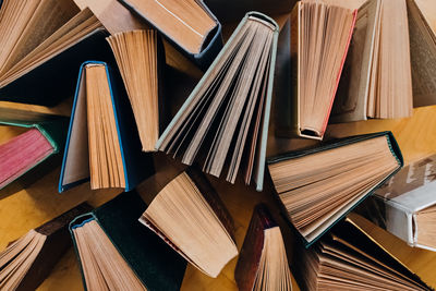 Group of books on wooden planks background, top view