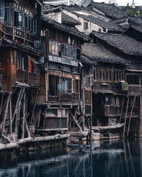 Old building by river in city