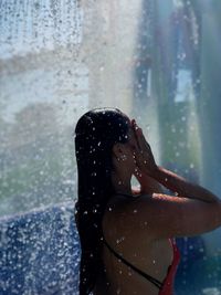 Young woman bathing outdoors