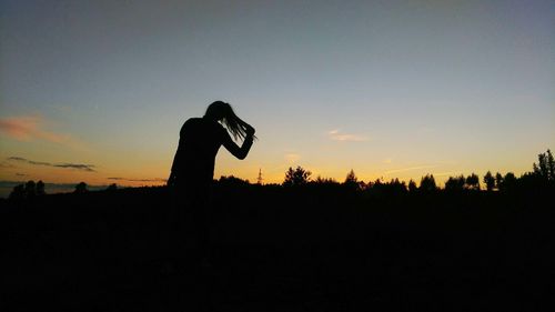 Silhouette man against clear sky at sunset