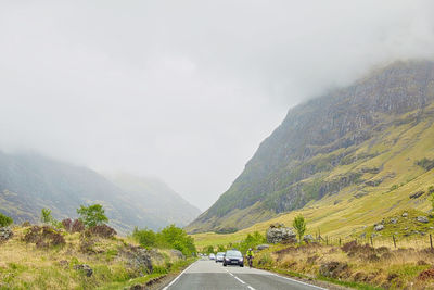 Road amidst mountains against sky