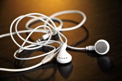 Close-up of in-ear headphones on table