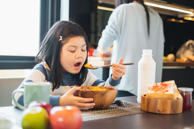 Woman holding food on table