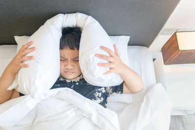 Portrait of boy lying on bed