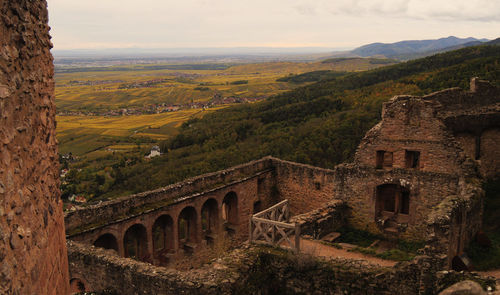 Arch bridge over mountains against sky