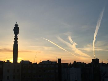 Silhouette buildings against sky during sunset