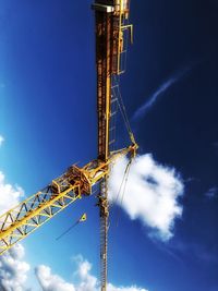 Low angle view of crane against blue sky