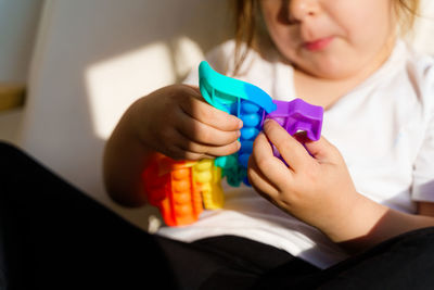 Midsection of girl playing with toy