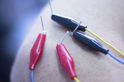 High angle view of electrical equipment on human skin