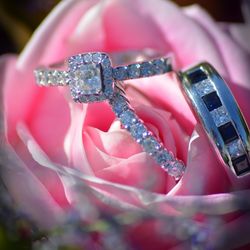 Close-up of wedding rings on pink rose