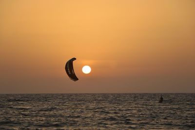 Scenic view of sea against orange sky