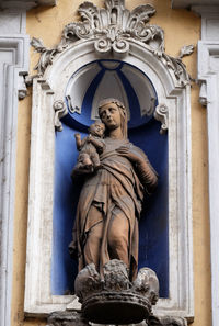 Statue of buddha against building