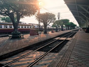 Railroad tracks in city against sky