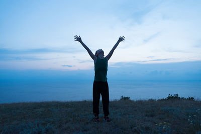 Man standing by sea against sky