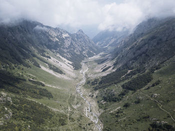 Scenic view of valley and mountains against sky