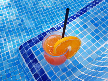 High angle view of orange juice on tiled floor