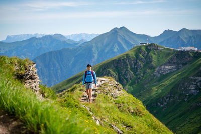 Full length of man standing on mountain against mountains