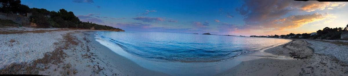 Panoramic view of beach against sky during sunset