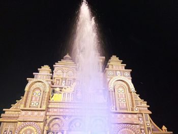 Low angle view of illuminated building at night