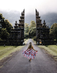 Rear view of woman walking in temple