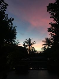 Silhouette palm trees against sky during sunset