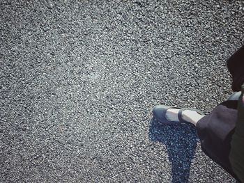 Low section of man standing on road