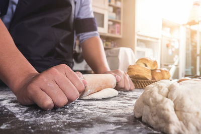 Midsection of man preparing food in store